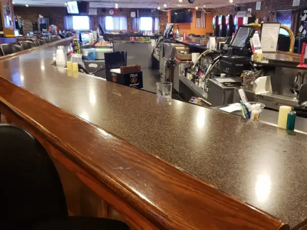The long polished bar counter inside the Aurora Turners bar and grille