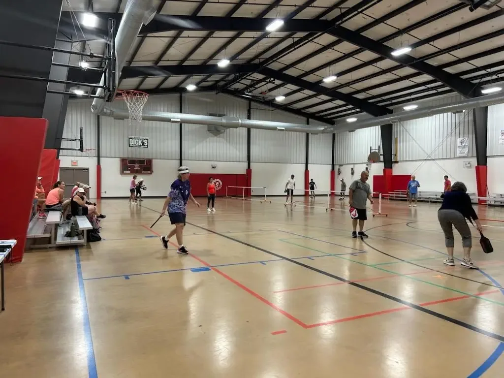 Members playing pickleball on the indoor court at Aurora Turners